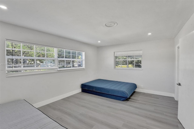 bedroom with recessed lighting, baseboards, and multiple windows