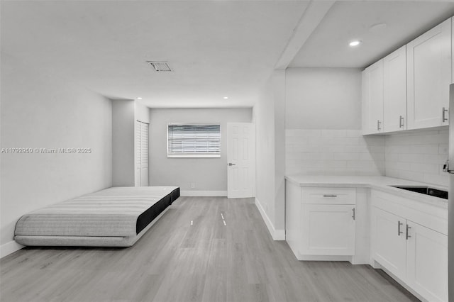 unfurnished bedroom with recessed lighting, baseboards, visible vents, and light wood finished floors