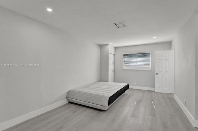 bedroom featuring recessed lighting, baseboards, visible vents, and wood finished floors