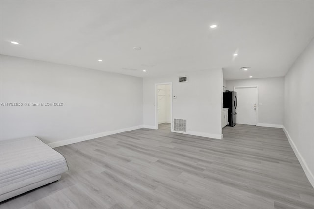 unfurnished room featuring visible vents, recessed lighting, baseboards, and light wood-style flooring