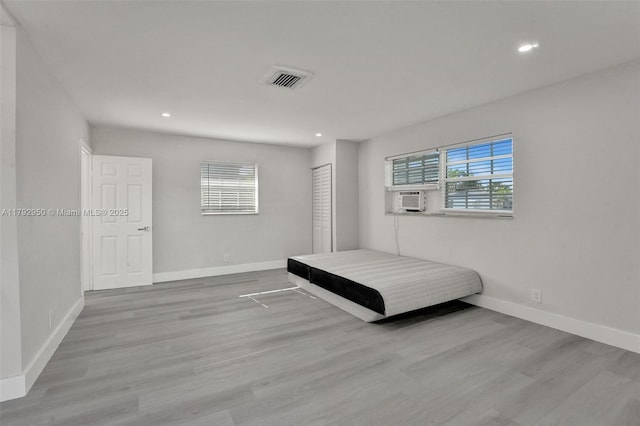 bedroom with recessed lighting, cooling unit, and wood finished floors