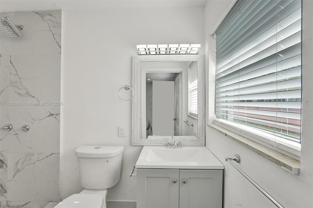 bathroom featuring vanity, toilet, and a marble finish shower