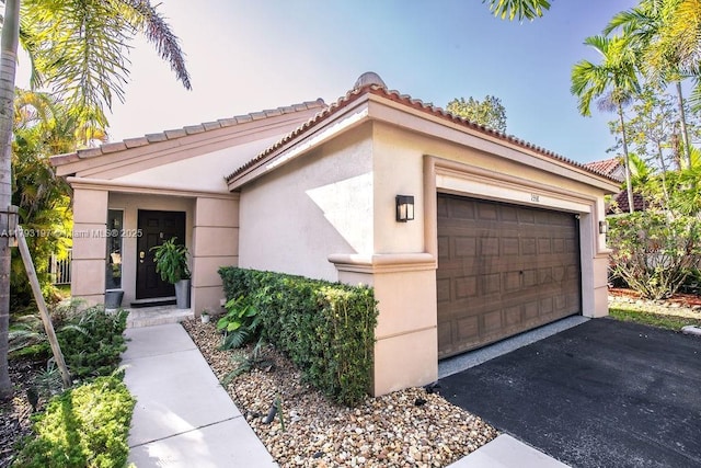1558 Sunset Way, Weston, FL 33327 - view of front facade with a tiled roof, an attached garage, aphalt driveway, and stucco siding