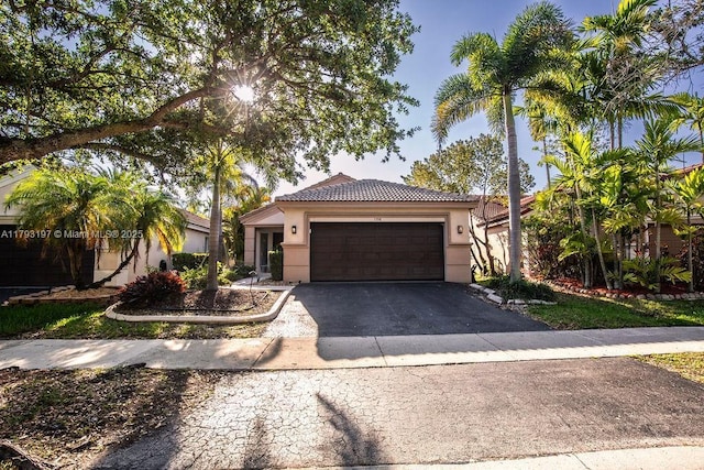 1558 Sunset Way, Weston, FL 33327 - ranch-style home featuring an attached garage, aphalt driveway, stucco siding, and a tiled roof