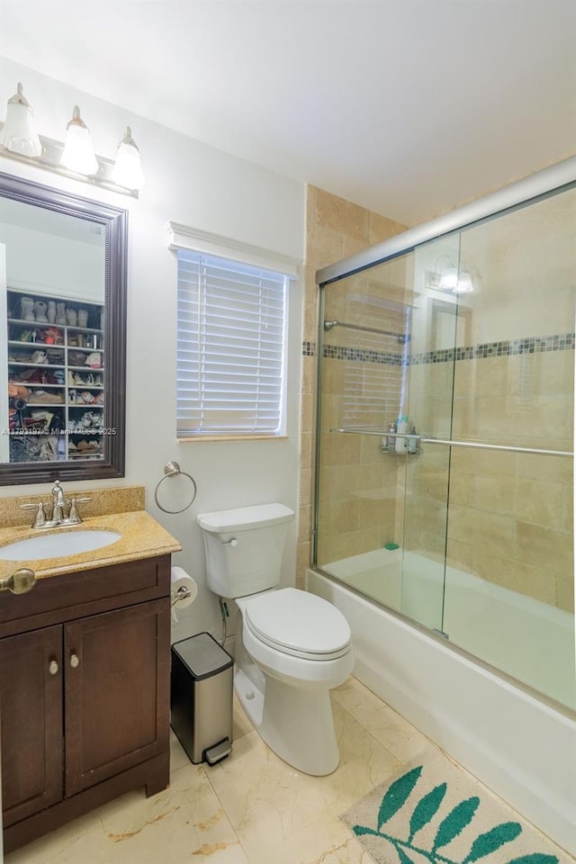 1558 Sunset Way, Weston, FL 33327 - full bath with shower / bath combination with glass door, toilet, marble finish floor, and vanity