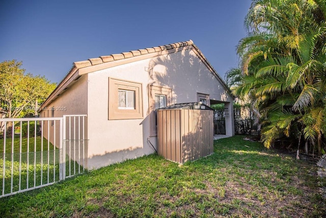 1558 Sunset Way, Weston, FL 33327 - view of side of home featuring a lawn, fence, a storage shed, and stucco siding