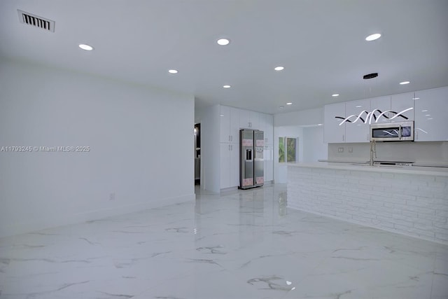 interior space with visible vents, appliances with stainless steel finishes, modern cabinets, white cabinets, and recessed lighting