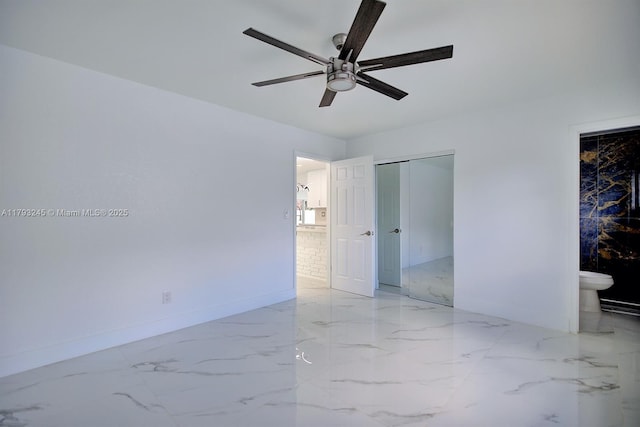 unfurnished bedroom with multiple closets, baseboards, ceiling fan, and marble finish floor
