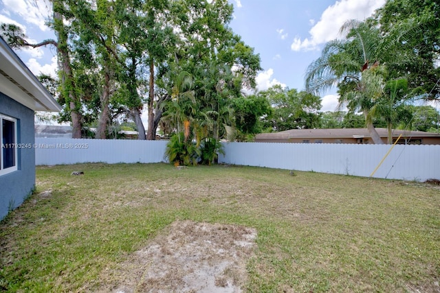 view of yard with a fenced backyard