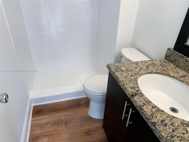 492 NW 165th St Rd Unit C-215, Miami, FL 33169 - full bathroom with vanity, wood finished floors, toilet, and tiled shower
