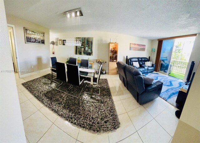 7705 Abbott Ave Unit 206, Miami Beach, FL 33141 - living area featuring a textured ceiling and light tile patterned flooring