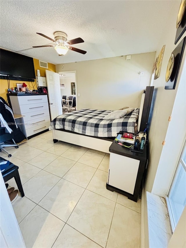 7705 Abbott Ave Unit 206, Miami Beach, FL 33141 - bedroom with a ceiling fan, a textured ceiling, visible vents, and light tile patterned floors