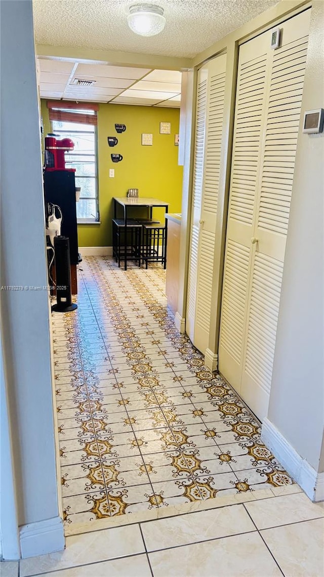 7705 Abbott Ave Unit 206, Miami Beach, FL 33141 - hall featuring visible vents, baseboards, and tile patterned floors