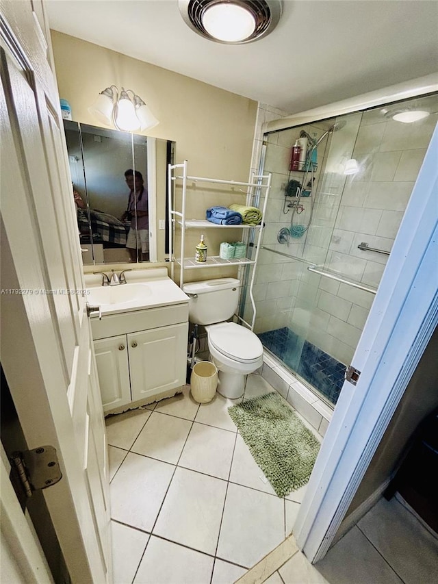 7705 Abbott Ave Unit 206, Miami Beach, FL 33141 - full bathroom with vanity, tile patterned flooring, a stall shower, and toilet