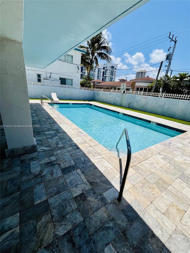 7705 Abbott Ave Unit 206, Miami Beach, FL 33141 - view of swimming pool featuring a fenced in pool, a fenced backyard, and a patio area