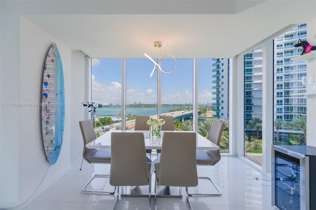 10275 Collins Ave Unit 731, Bal Harbour, FL 33154 - tiled dining area with a water view, beverage cooler, baseboards, and a wall of windows