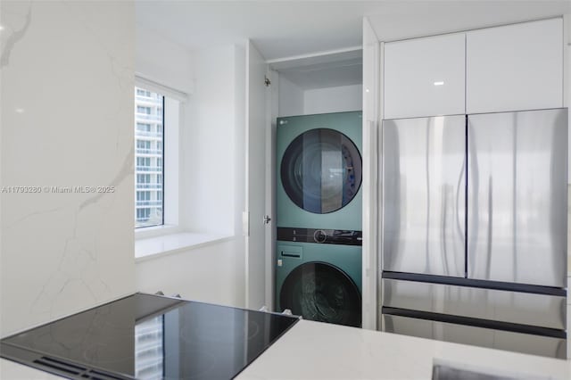 10275 Collins Ave Unit 731, Bal Harbour, FL 33154 - washroom featuring stacked washer / dryer