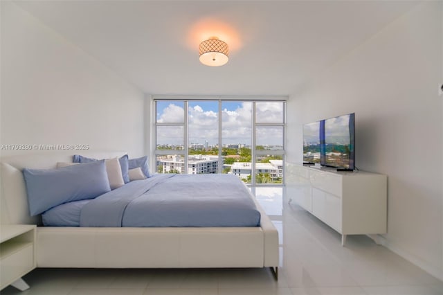 10275 Collins Ave Unit 731, Bal Harbour, FL 33154 - bedroom with light tile patterned floors and a wall of windows