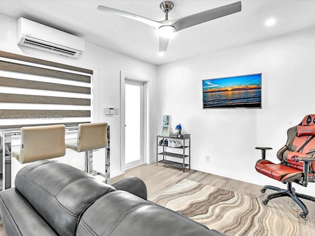 living room featuring ceiling fan, a wall mounted air conditioner, recessed lighting, baseboards, and wood finished floors