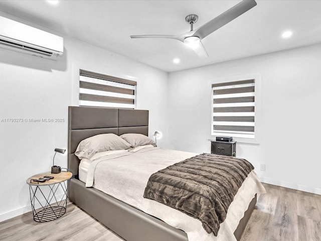 bedroom with recessed lighting, a wall mounted air conditioner, and wood finished floors