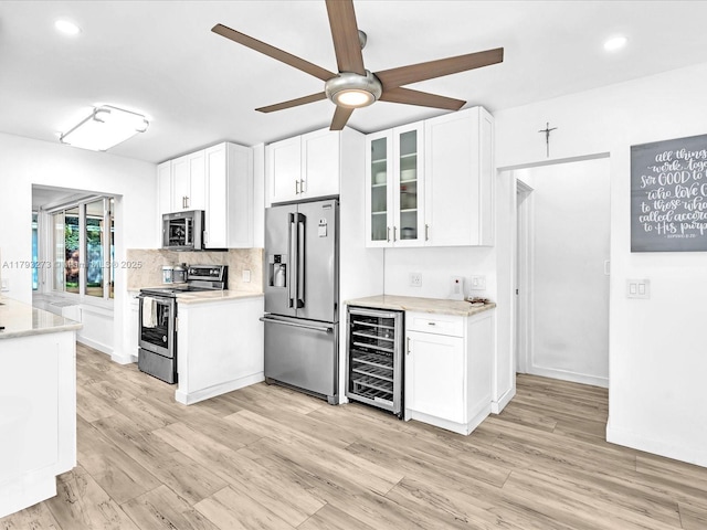 kitchen with white cabinets, stainless steel appliances, a ceiling fan, and wine cooler