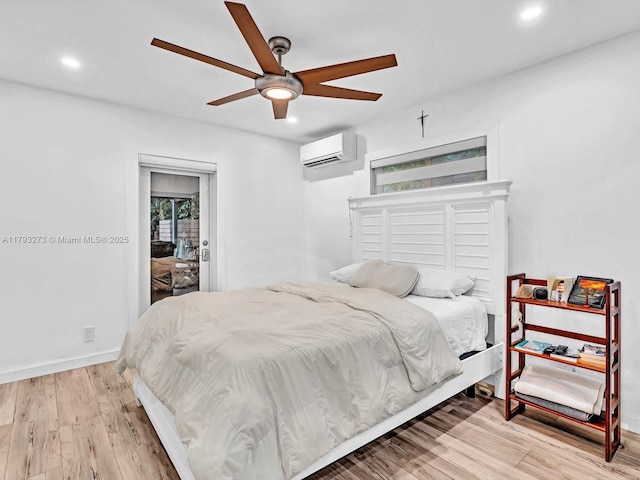 bedroom with baseboards, recessed lighting, a wall mounted air conditioner, and wood finished floors