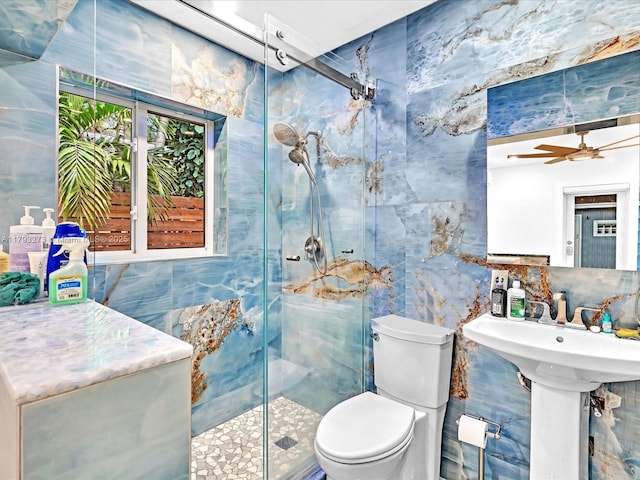 bathroom featuring toilet, a ceiling fan, tile walls, and a shower stall