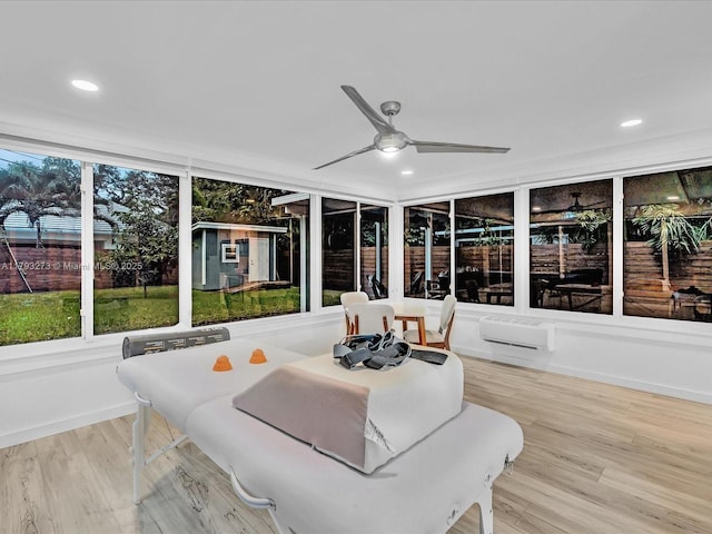 sunroom featuring a wooden deck, recessed lighting, wood finished floors, and an AC wall unit