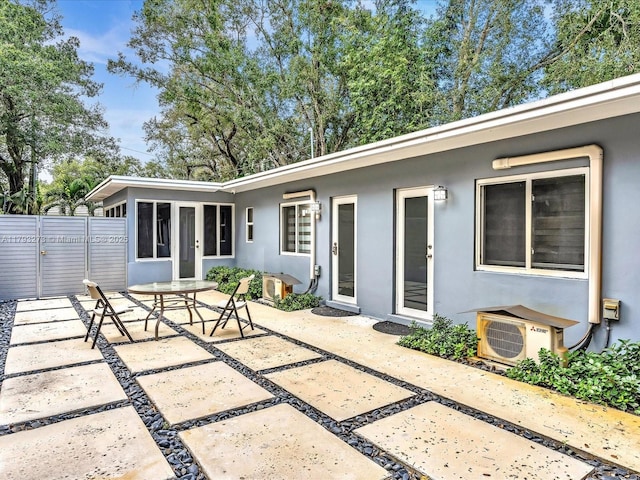 view of patio / terrace featuring ac unit and fence