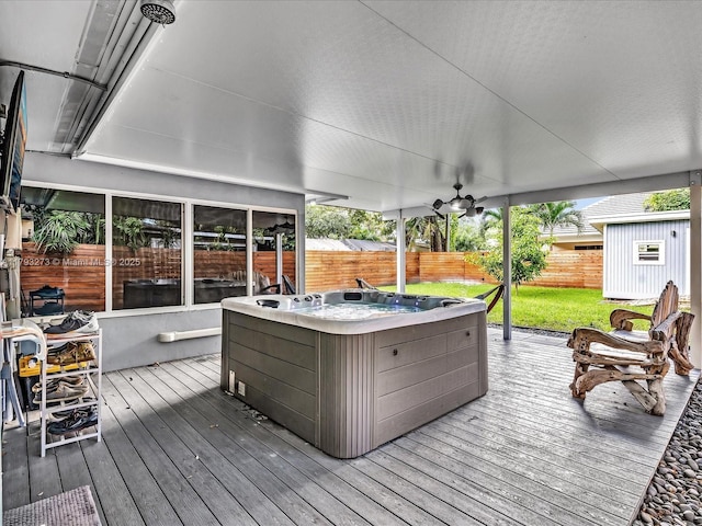 wooden deck featuring a hot tub and a fenced backyard