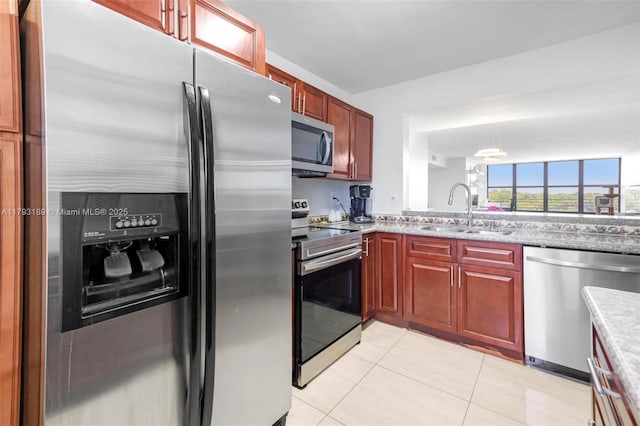 2767 S Carambola Cir S Unit 506, Coconut Creek, FL 33066 - kitchen featuring stainless steel appliances, a sink, light tile patterned flooring, and dark brown cabinets