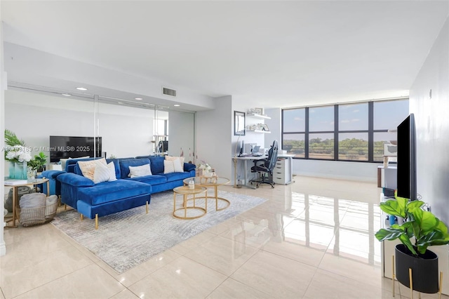 living room with tile patterned floors and visible vents