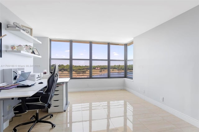 office area featuring baseboards and light tile patterned floors
