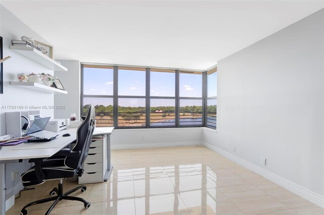 2767 S Carambola Cir S Unit 506, Coconut Creek, FL 33066 - home office with baseboards and light tile patterned flooring