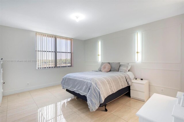 2767 S Carambola Cir S Unit 506, Coconut Creek, FL 33066 - bedroom featuring light tile patterned floors and baseboards