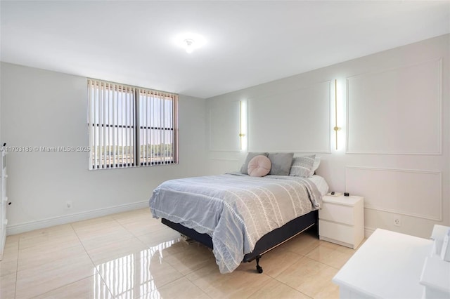bedroom featuring baseboards and light tile patterned flooring