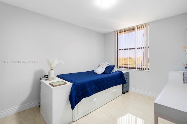 tiled bedroom featuring baseboards