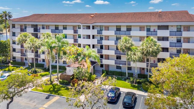 2767 S Carambola Cir S Unit 506, Coconut Creek, FL 33066 - view of apartment building / complex featuring uncovered parking