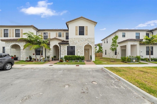 12901 SW 232nd Ln, Homestead, FL 33032 - mediterranean / spanish-style home featuring stucco siding, a front yard, and stone siding