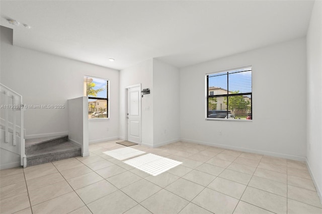 12901 SW 232nd Ln, Homestead, FL 33032 - unfurnished room with light tile patterned flooring, baseboards, and stairway