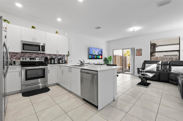 12901 SW 232nd Ln, Homestead, FL 33032 - kitchen featuring visible vents, a sink, a peninsula, open floor plan, and stainless steel appliances