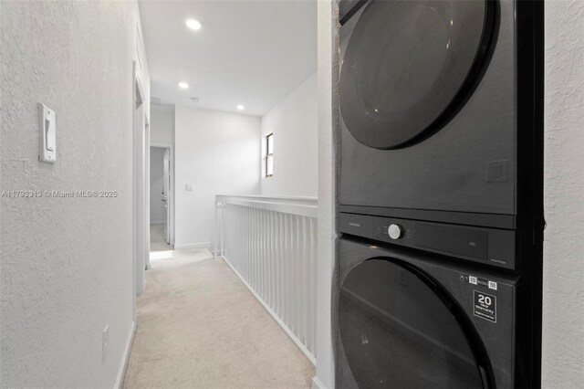 12901 SW 232nd Ln, Homestead, FL 33032 - clothes washing area featuring a textured wall, carpet, stacked washer and clothes dryer, and laundry area
