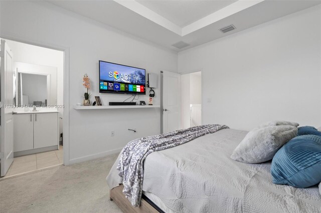 12901 SW 232nd Ln, Homestead, FL 33032 - bedroom featuring visible vents, light carpet, baseboards, connected bathroom, and light tile patterned floors
