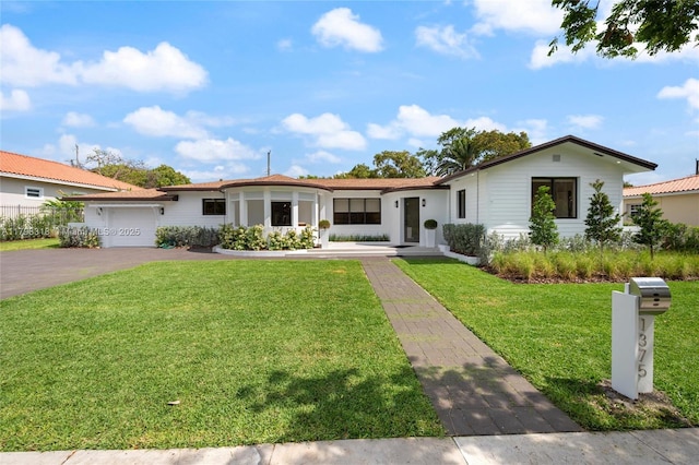1375 SW 17th Ter, Miami, FL 33145 - view of front facade featuring a garage, a front yard, asphalt driveway, and stucco siding