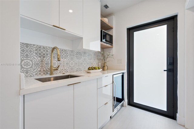 1375 SW 17th Ter, Miami, FL 33145 - kitchen with a sink, modern cabinets, white cabinets, and beverage cooler