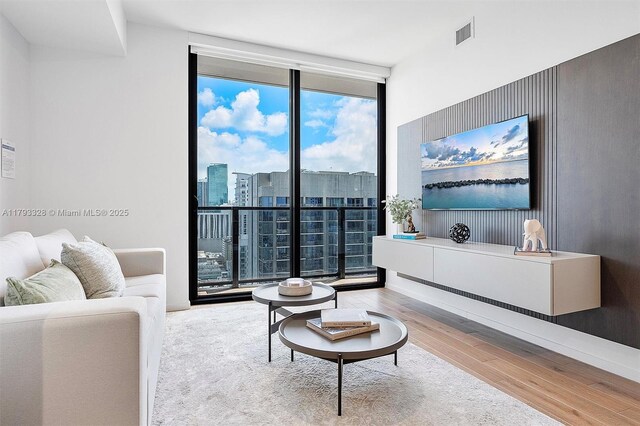 398 NE 5th St Unit 2517, Miami, FL 33132 - living area with wood-type flooring, expansive windows, and visible vents