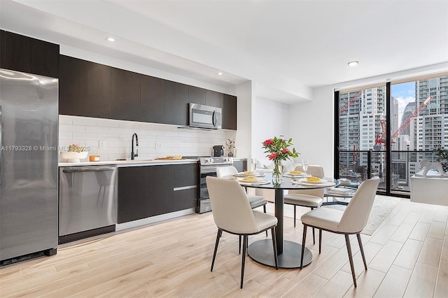 398 NE 5th St Unit 2517, Miami, FL 33132 - dining room with light wood-style floors, a view of city, recessed lighting, and expansive windows