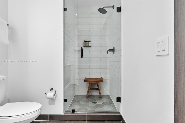398 NE 5th St Unit 2517, Miami, FL 33132 - bathroom with tile patterned flooring, toilet, and a shower stall