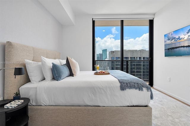 398 NE 5th St Unit 2517, Miami, FL 33132 - bedroom featuring baseboards and a wall of windows