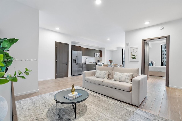 398 NE 5th St Unit 2517, Miami, FL 33132 - living room featuring baseboards, recessed lighting, and light wood-style flooring